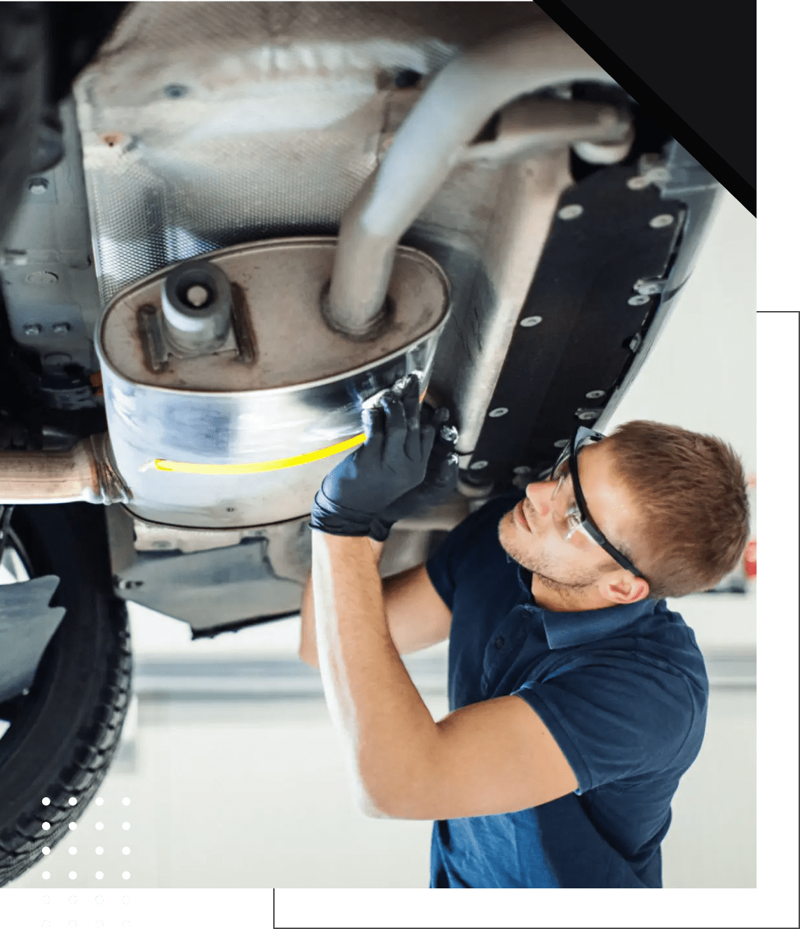 Worker examines vehicle undercarriage