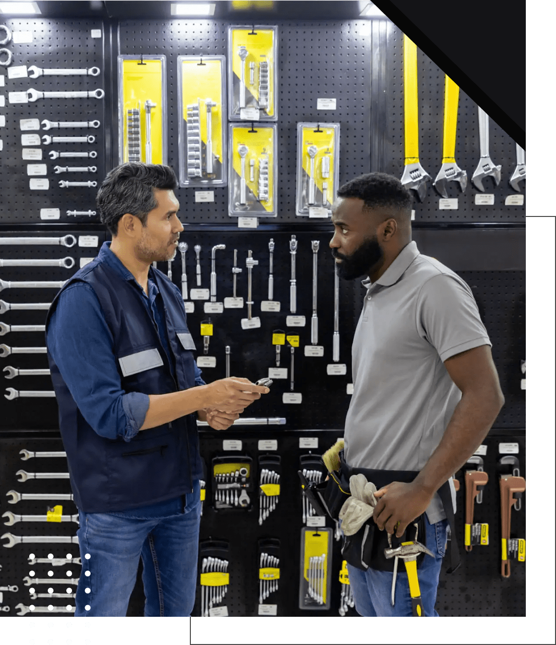Two men talking in hardware store aisle.