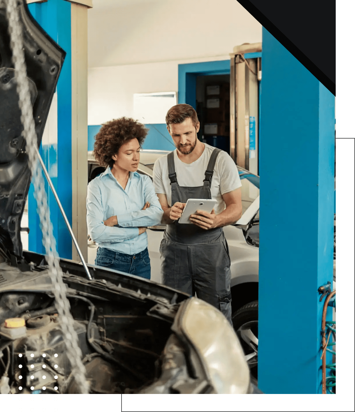 Mechanic discussing car repair with customer.