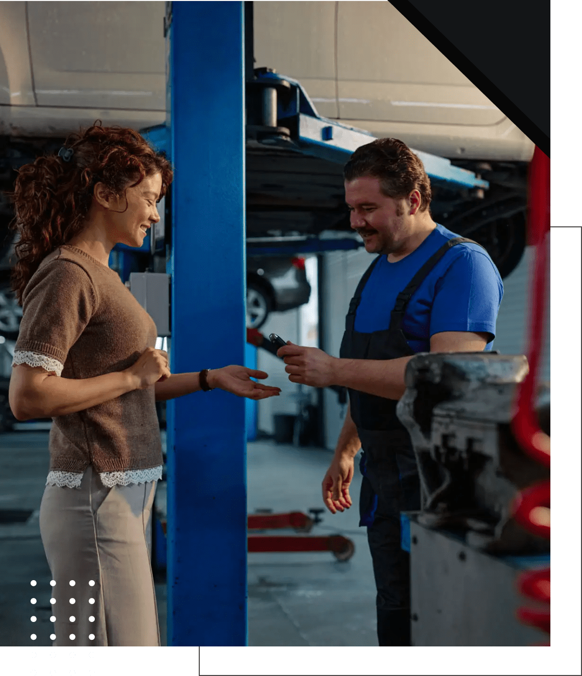 Woman receiving car keys from mechanic.