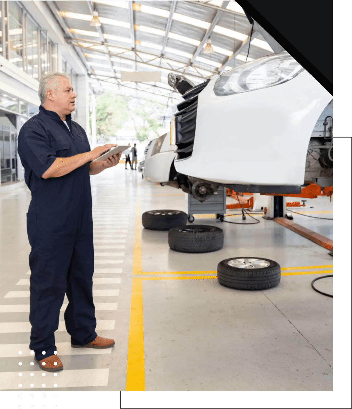 Auto technician with raised vehicle