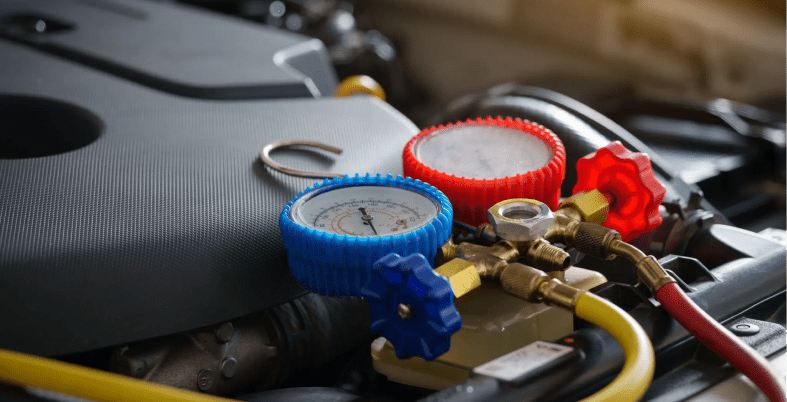 Car engine with pressure gauges attached.