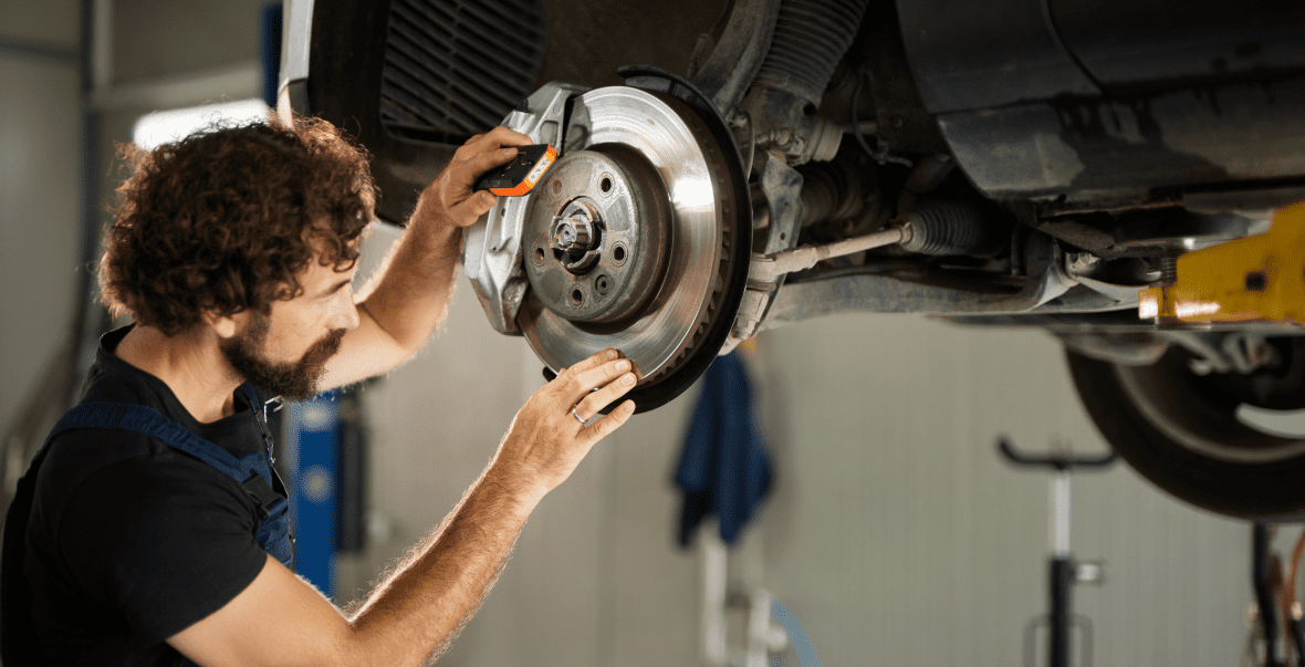 Man working on vehicle brakes