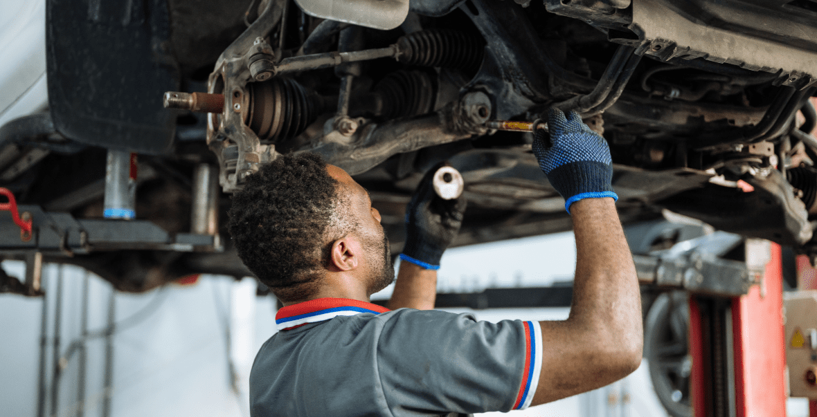 Mechanic working under a car