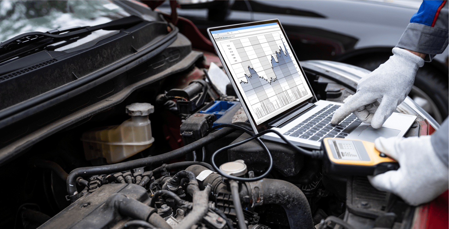 Laptop displaying engine diagnostic graphs