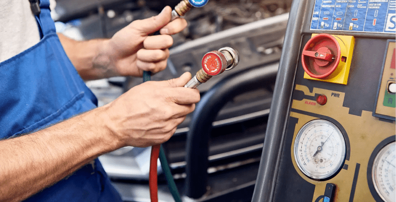 Mechanic using gauges for car diagnostics.