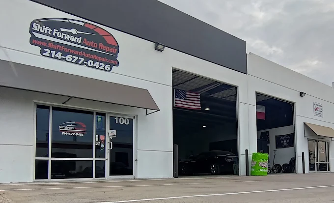 Auto repair shop exterior with open garage bays